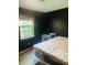 This bedroom boasts dark walls, a window for natural light, and space for a desk setup, offering a quiet retreat at 8318 Rob Ln, Indianapolis, IN 46237