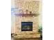Close-up of the stone fireplace with wooden mantel, perfect for cozy evenings at 8318 Rob Ln, Indianapolis, IN 46237