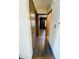 Hallway with wood-look floors and neutral walls leads to other rooms, creating a seamless transition throughout the home at 8318 Rob Ln, Indianapolis, IN 46237