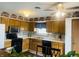 Bright kitchen with oak cabinets, mosaic backsplash and black appliances at 8318 Rob Ln, Indianapolis, IN 46237