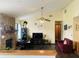 Spacious living room with stone fireplace, ceiling fan, and dark wood floors offers a cozy atmosphere at 8318 Rob Ln, Indianapolis, IN 46237