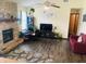 Inviting living room featuring a stone fireplace, hardwood floors and large windows at 8318 Rob Ln, Indianapolis, IN 46237