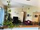 Bright living room featuring a vaulted ceiling, ceiling fan, and stone fireplace offers ample space at 8318 Rob Ln, Indianapolis, IN 46237