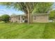 Backyard view showcasing a mature shade tree and stone exterior walls at 861 Westbrook Dr, Mooresville, IN 46158