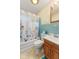 This bathroom features blue tile, and a shower/tub combo with a floral shower curtain at 861 Westbrook Dr, Mooresville, IN 46158