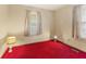 Traditional bedroom featuring red carpet, neutral walls, and abundant natural light at 861 Westbrook Dr, Mooresville, IN 46158