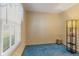 Inviting bedroom with window, blinds, patterned wallpaper, blue carpet, and vintage lamp at 861 Westbrook Dr, Mooresville, IN 46158