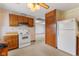 Well-lit kitchen includes white appliances and view to a separate dining or living space at 861 Westbrook Dr, Mooresville, IN 46158
