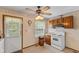 Compact kitchen features white appliances, wood cabinets, and convenient access to the backyard at 861 Westbrook Dr, Mooresville, IN 46158