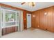 Cozy living room with wood paneled walls, plush carpet, and ample natural light at 861 Westbrook Dr, Mooresville, IN 46158