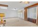 Bright living room featuring plush carpeting, skylight, and sliding glass doors to the outdoors at 861 Westbrook Dr, Mooresville, IN 46158