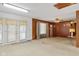 Spacious living room with skylight, carpet, and wood paneled walls, offering charm at 861 Westbrook Dr, Mooresville, IN 46158