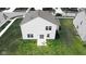 Aerial view of the home's backyard featuring a patio and seating on a lush lawn at 8690 Lester Pl, Pendleton, IN 46064