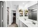 A bright ensuite bathroom featuring double sinks and a glass door shower and a large walk-in closet at 8690 Lester Pl, Pendleton, IN 46064