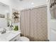 Charming bathroom featuring a modern vanity with a quartz countertop, decorative shelving, and a shower at 8690 Lester Pl, Pendleton, IN 46064