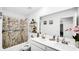 Well-lit bathroom features a double vanity, ample storage, and nautical themed decor at 8690 Lester Pl, Pendleton, IN 46064