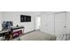 Contemporary bedroom includes a mounted TV, minimalist decor, and natural light at 8690 Lester Pl, Pendleton, IN 46064