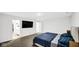 Bright bedroom featuring an entertainment center and access to the ensuite bathroom and closets at 8690 Lester Pl, Pendleton, IN 46064