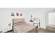 Bright bedroom boasts neutral walls, a comfortable bed, and a vanity for added convenience at 8690 Lester Pl, Pendleton, IN 46064
