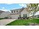Charming two-story home featuring a three-car garage, well-manicured lawn, and stylish architectural details at 8690 Lester Pl, Pendleton, IN 46064
