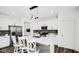 Modern kitchen boasts white cabinets, stainless steel appliances, and a stylish island with seating at 8690 Lester Pl, Pendleton, IN 46064