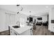 Bright kitchen offers views to the living and dining areas, with modern fixtures and stylish décor at 8690 Lester Pl, Pendleton, IN 46064
