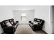 Inviting living room has two comfortable leather sofas, soft carpeting, and a bright window at 8690 Lester Pl, Pendleton, IN 46064