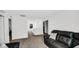 Spacious living room has a plush leather sofa, neutral paint, and soft carpeting throughout at 8690 Lester Pl, Pendleton, IN 46064