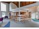 Bar area featuring a wooden counter with seating, stainless steel appliances, and an open view of the living space at 8720 Yardley Ct # 207, Indianapolis, IN 46268