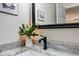 Marble bathroom countertop with a vessel sink, sleek faucet, and black-framed mirror at 8720 Yardley Ct # 207, Indianapolis, IN 46268