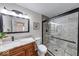 Bathroom with sleek black-framed glass shower door and brown vanity with a marble countertop at 8720 Yardley Ct # 207, Indianapolis, IN 46268