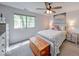 Cozy bedroom with natural light, quilt bed, and wood chest, creating a warm and inviting space at 8720 Yardley Ct # 207, Indianapolis, IN 46268