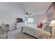 Spacious bedroom with neutral decor, ceiling fan, and ample natural light from the window at 8720 Yardley Ct # 207, Indianapolis, IN 46268