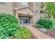 Inviting building entrance with manicured landscaping and clearly marked address at 8720 Yardley Ct # 207, Indianapolis, IN 46268