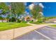 Well-maintained community clubhouse with lush landscaping and American flag at 8720 Yardley Ct # 207, Indianapolis, IN 46268