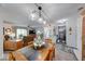 Open-concept dining room featuring a statement light fixture and seamless flow to the kitchen and living room at 8720 Yardley Ct # 207, Indianapolis, IN 46268