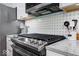 Close up view of kitchen with stainless steel oven, range, granite countertops and backsplash at 8720 Yardley Ct # 207, Indianapolis, IN 46268