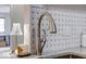 Close-up of kitchen faucet, sink, and countertop with tile backsplash, showcasing modern design and functionality at 8720 Yardley Ct # 207, Indianapolis, IN 46268