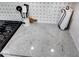 Kitchen with granite countertop, gas range and mosaic backsplash, and stainless steel fixtures at 8720 Yardley Ct # 207, Indianapolis, IN 46268