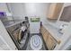 Modern laundry room with stainless steel washer and dryer, grey flooring, and folding counter at 8720 Yardley Ct # 207, Indianapolis, IN 46268