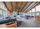 Living area featuring a wooden ceiling, fireplace, ample natural light, and comfortable seating at 8720 Yardley Ct # 207, Indianapolis, IN 46268