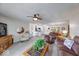 Open-concept living area with a ceiling fan, seamlessly connected to the kitchen and dining spaces at 8720 Yardley Ct # 207, Indianapolis, IN 46268