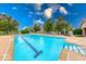 Community swimming pool features a gazebo, lounge chairs, and beautiful landscaping at 8720 Yardley Ct # 207, Indianapolis, IN 46268