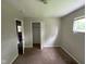 Vacant carpeted bedroom with standard closet, window and neutral paint at 9045 Stardust Dr, Indianapolis, IN 46229