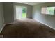 View of carpeted living room with sliding glass doors leading to the outside at 9045 Stardust Dr, Indianapolis, IN 46229
