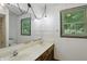 Bright bathroom with a double vanity, shower, and window with blinds at 9101 Ditch Rd, Indianapolis, IN 46260