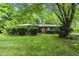 Charming single-story brick home with a well-maintained lawn and mature trees at 9101 Ditch Rd, Indianapolis, IN 46260