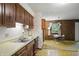 View of kitchen sink and wood cabinets extending into adjacent dining space, ready for entertaining at 9101 Ditch Rd, Indianapolis, IN 46260