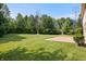 A spacious backyard with green grass and privacy from the surrounding woods at 9205 Selkirk Ct, Indianapolis, IN 46260