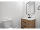 Bathroom featuring a wood vanity, white countertop, modern black faucet, mirror and toilet at 9205 Selkirk Ct, Indianapolis, IN 46260
